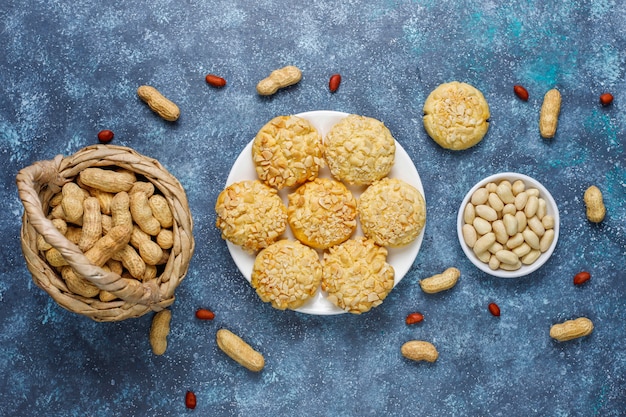 Homemade crunchy cookies with peanuts on grey, top view