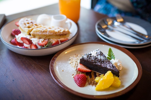 homemade dark chocolate brownies and strawberry and fresh orrange