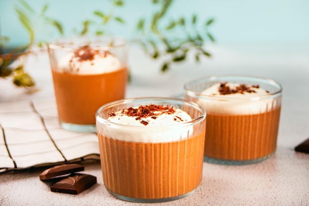 Homemade delicious chocolate mousse panna cotta pudding whipped cream in a glasses