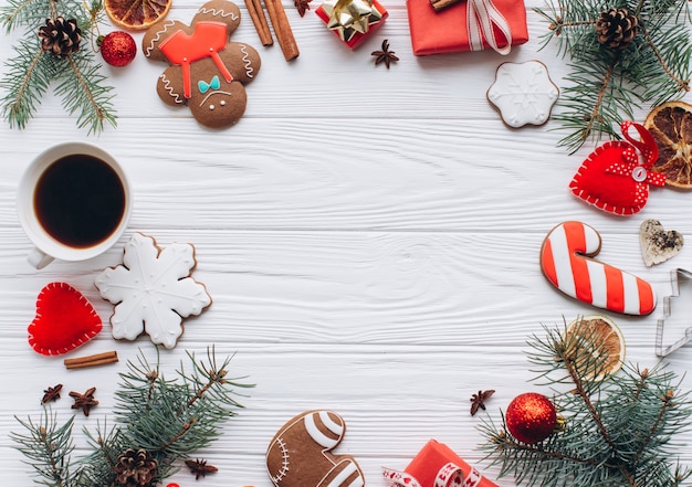 Homemade delicious Christmas gingerbread cookies on the white wooden background.