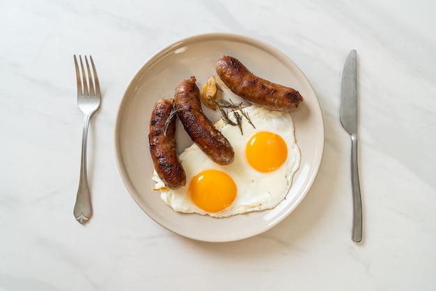 homemade double fried egg with fried pork sausage - for breakfast