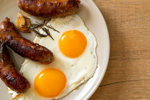 homemade double fried egg with fried pork sausage - for breakfast