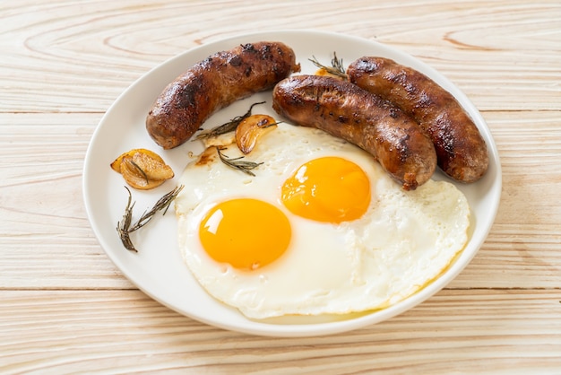 homemade double fried egg with fried pork sausage - for breakfast