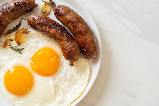 homemade double fried egg with fried pork sausage for breakfast