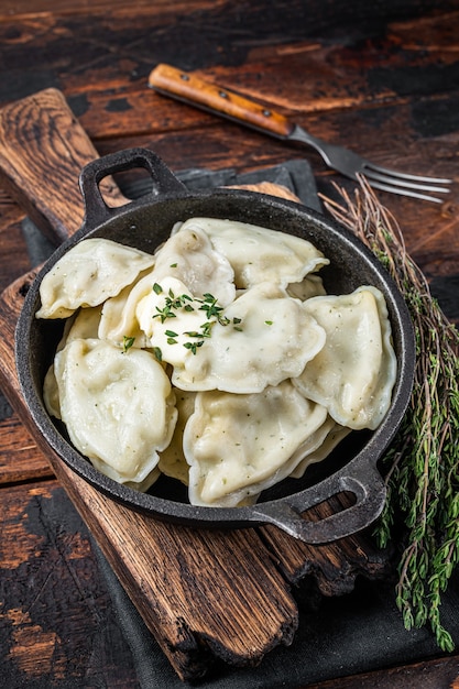 Homemade dumplings, vareniki, pierogi stuffed with potato in a pan