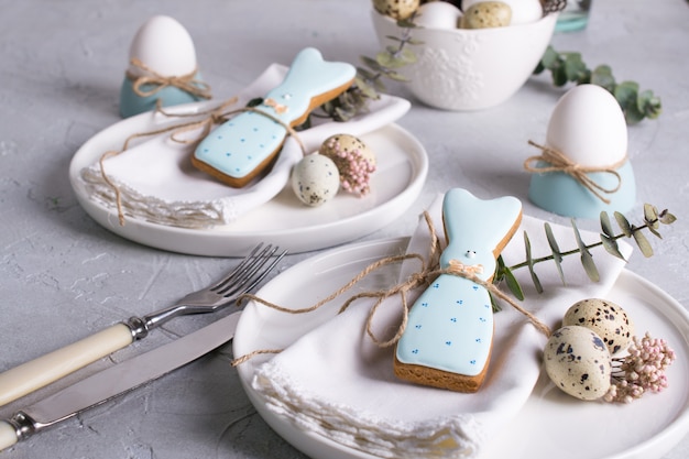 Homemade easter cookies in the shape of  a  funny  rabbit  on white plate. Easter  festive table setting. Holiday decorations.