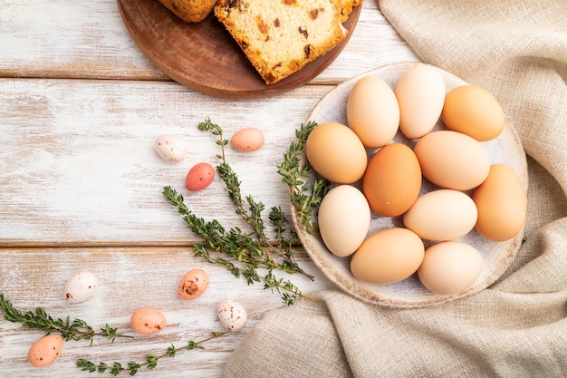 Homemade easter pie with raisins and eggs on plate on a white wooden background top view close up