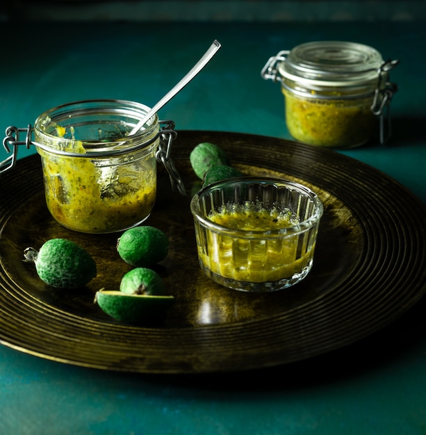 Homemade feijoa jam and fresh fruit on serving plate