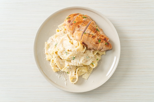 homemade fettucine pasta white creamy sauce with grilled chicken