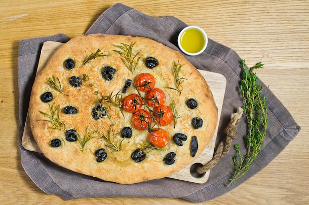 Homemade Focaccia on a wooden table.  