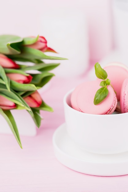 Homemade french dessert pink  macarons and spring tulips