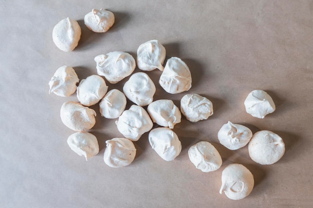 Homemade french milkcolored meringues on crumpled craft paper