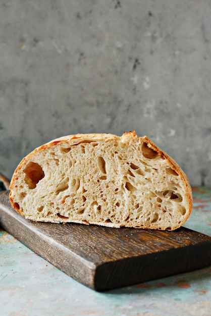 Homemade Freshly Bread  made from wheat and whole grain flour on a gray wall.