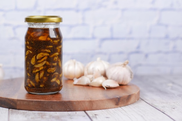 Homemade Garlic Pickle in a glass jar on table