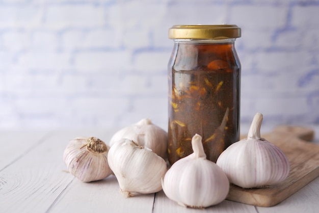 Homemade Garlic Pickle in a glass jar on table