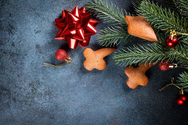 Homemade gingerbread cookies on dark background Christmas composition new year background Christmas dessert New Year flatlay