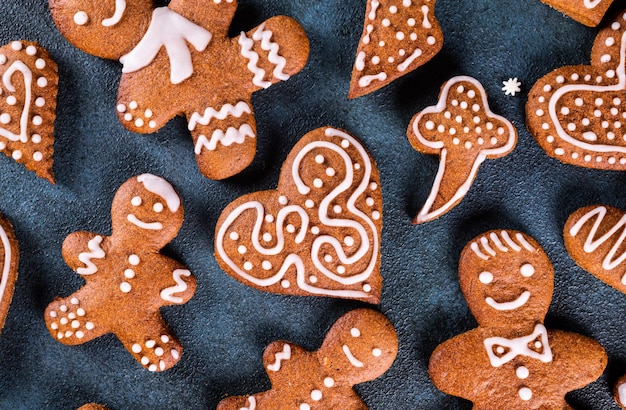 Homemade gingerbread cookies on dark background Christmas composition new year background Christmas dessert New Year flatlay