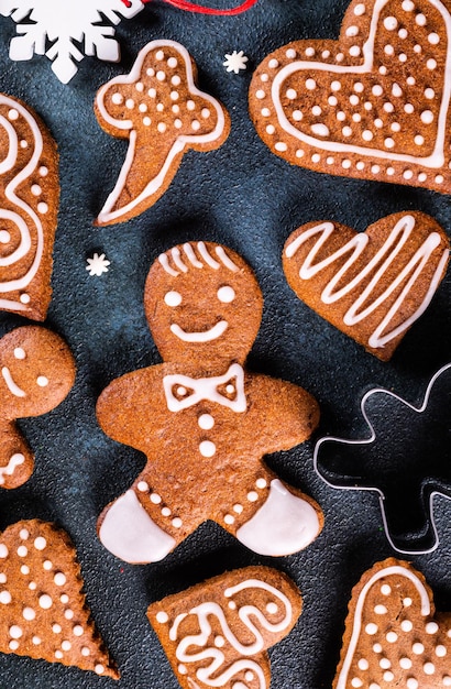 Homemade gingerbread cookies on dark background Christmas composition new year background Christmas dessert New Year flatlay