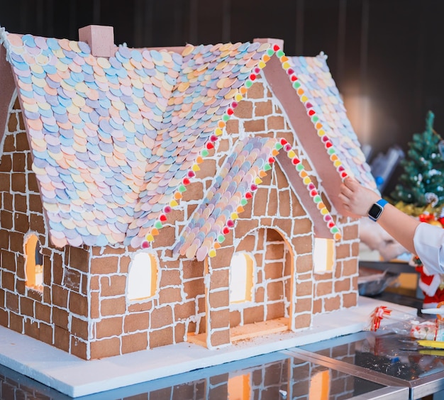 Homemade gingerbread house on Winter season. Merry Christmas and Happy New Year decoration at home.