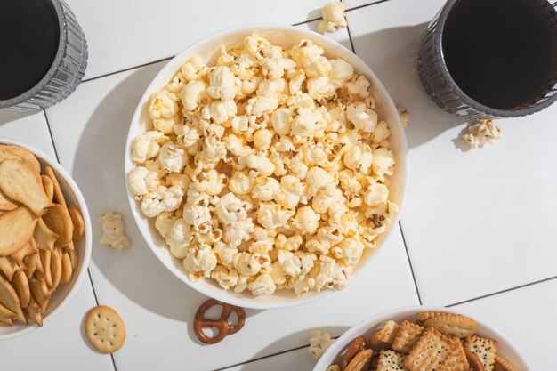 Homemade goodies fast food a bowl with popcorn crackers and cookies on a white table