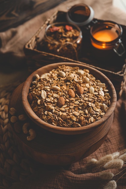 Homemade granola in a wooden bowl in a homely atmosphere