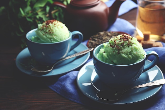 Homemade Green tea icecream in cup on wooden background