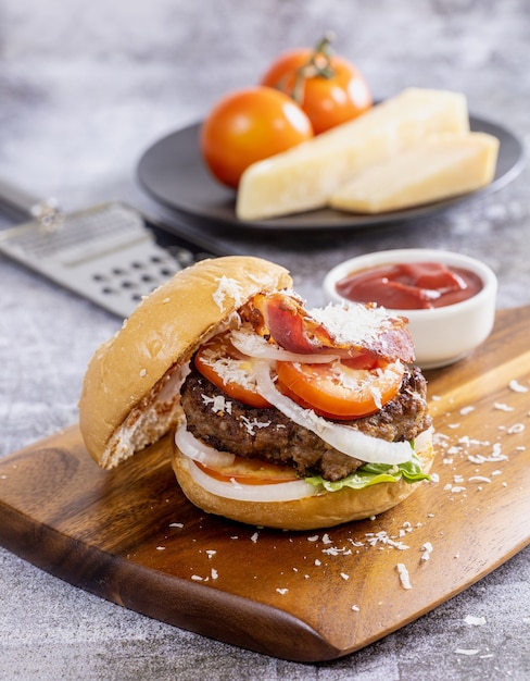 Homemade grilled cheese burger with lettuce on wooden board