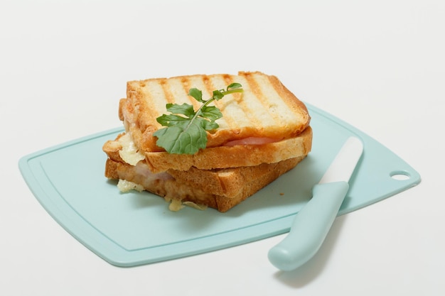 Homemade grilled cheese sandwich for breakfast on cutting board.