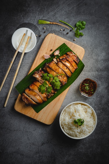 Homemade Grilled chicken fillets on a wood board on the table Horizontal top view from above