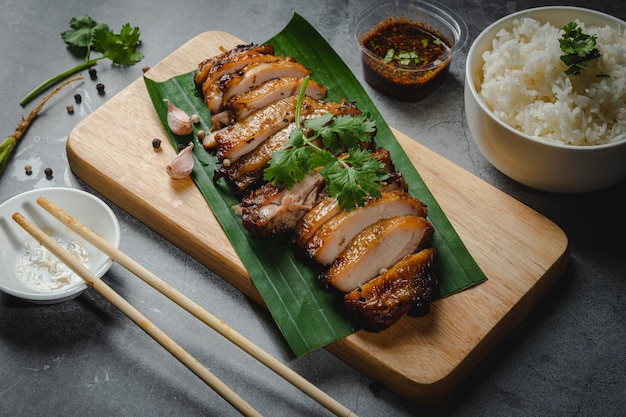 Homemade Grilled chicken fillets on a wood board on the table Horizontal top view from above