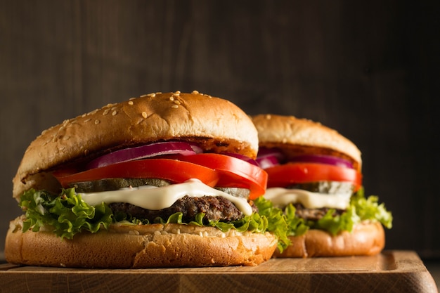 Homemade hamburger with beef, onion, tomato, lettuce and cheese