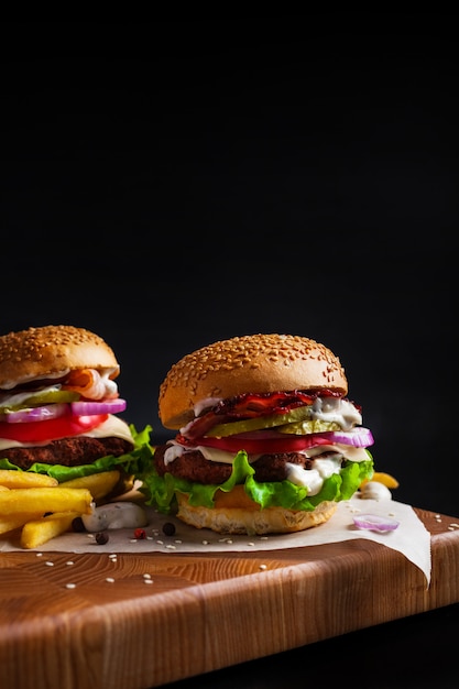 Homemade hamburgers on a blackboard on a black background