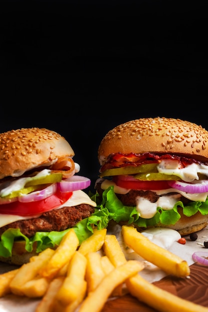 Homemade hamburgers on a blackboard on a black background