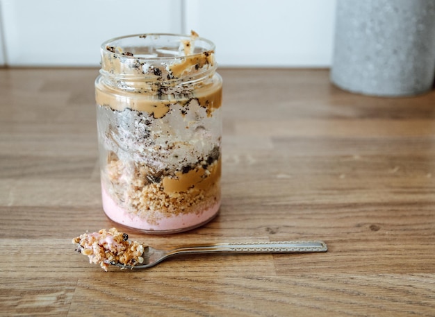 Homemade hazelnut spread in glass jar with nuts