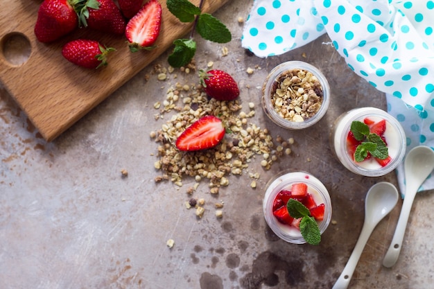 Homemade healthy breakfast with homemade baked granola fresh strawberry and yogurt Copy space