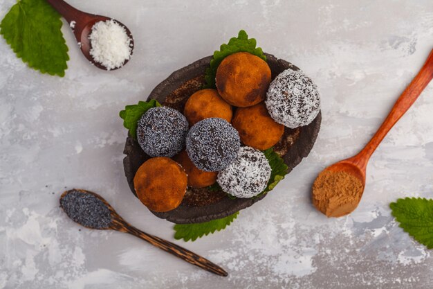 Homemade Healthy vegan Raw Energy Balls with carob, a poppy and coconut, top view. Healthy vegan food concept.