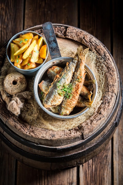 Homemade herring fish and chips with salt and herbs