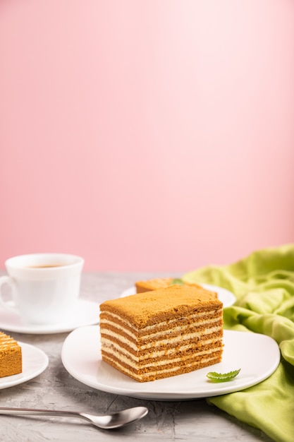 Homemade honey cake with milk cream and mint with cup of coffee