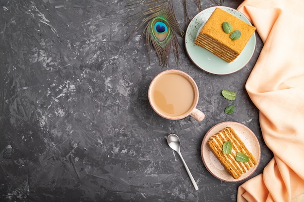 Homemade honey cake with milk cream and mint with cup of coffee