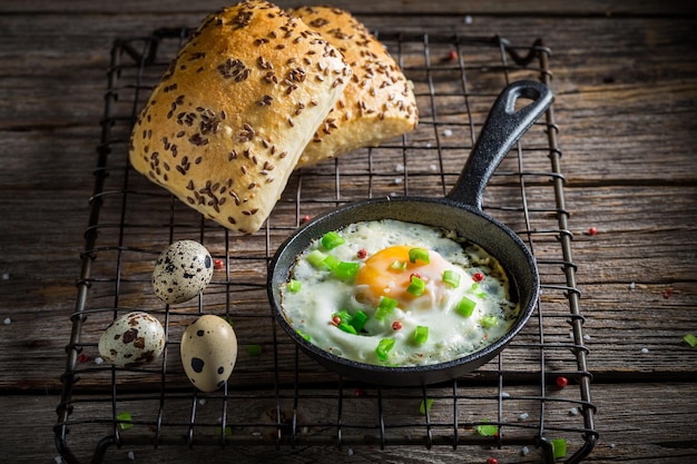 Homemade and hot fried eggs served with chive and roll