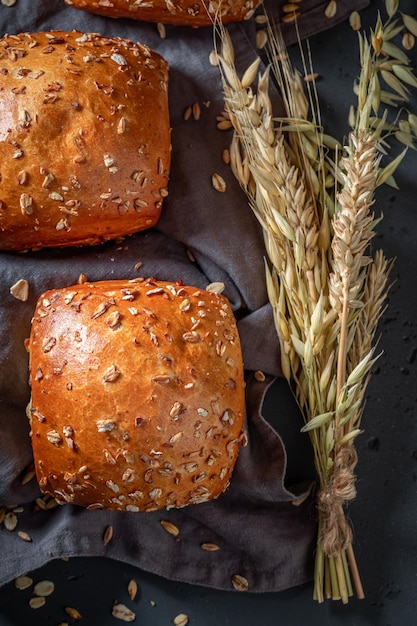 Homemade and hot oat buns baked in rustic kitchen