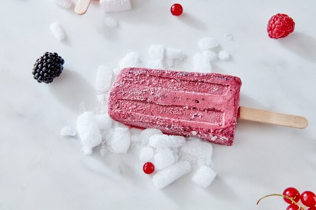 Homemade ice cream on a stick with a piece of fruits