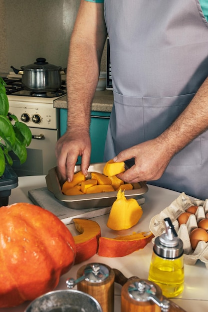 Homemade Italian pumpkin ricotta ravioli Man prepares for baking pumpkin