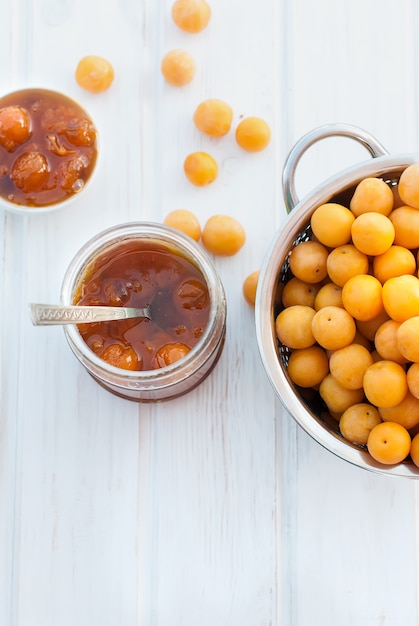 Homemade jam of yellow plum on a white board