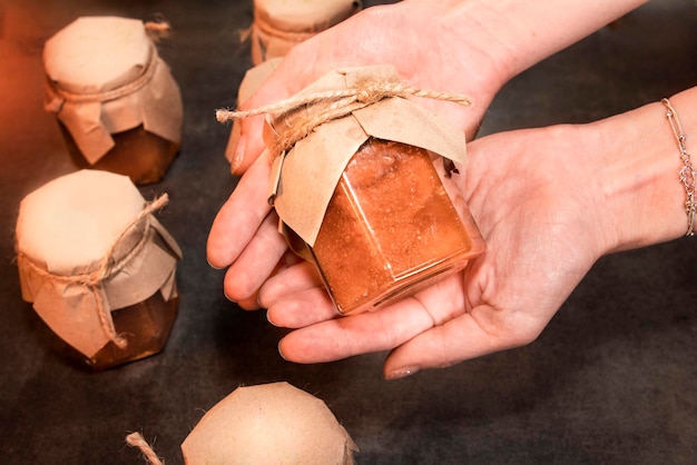 Homemade jams made from organic products in a jar for serving in the girls hands