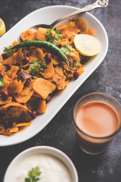 Homemade Kothu Parotta or Paratha or Stir Fried Leftover Chapati Masala or  fodnichi poli in marathi, served in a bowl or plate with curd and hot tea. Selective focus