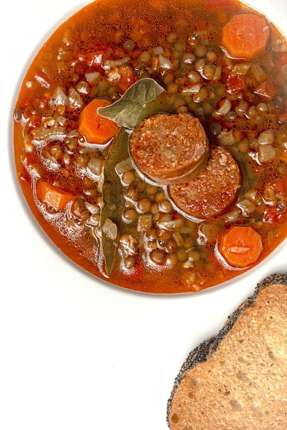 Homemade lentil stew with vegetables and chorizo