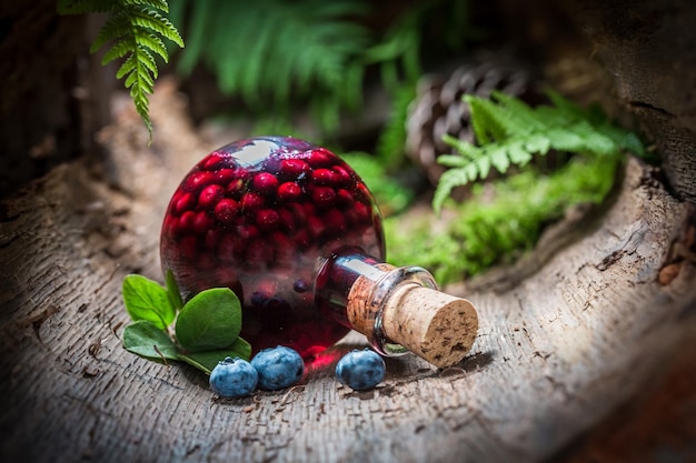 Homemade liqueur made of blueberries and alcohol in summer