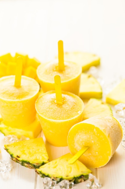 Homemade low calorie popsicles made with mando, pineapple and cocconut milk.