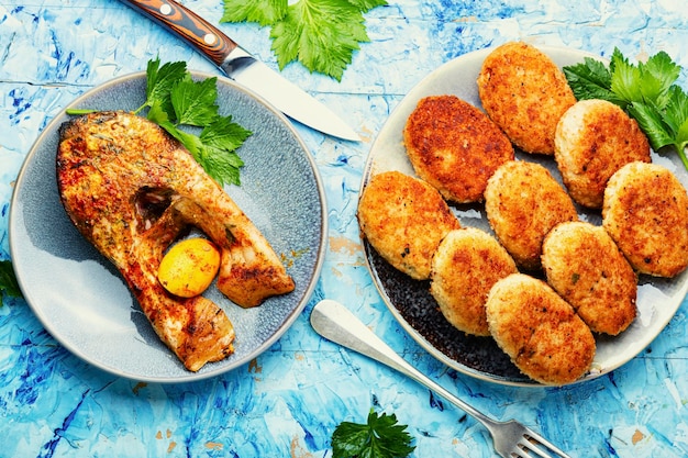 Homemade minced fish cutlets and fish steak. Top view